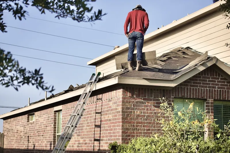 Professional roofer working on a residential roof in Cross-County
